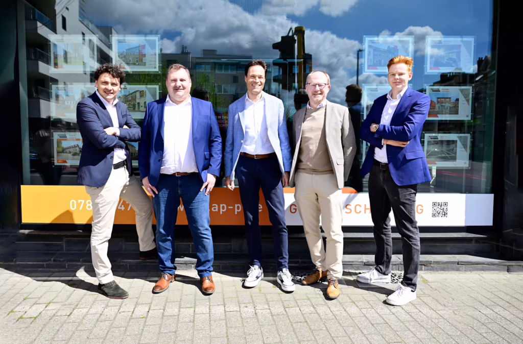 Five business professionals standing together outside an office